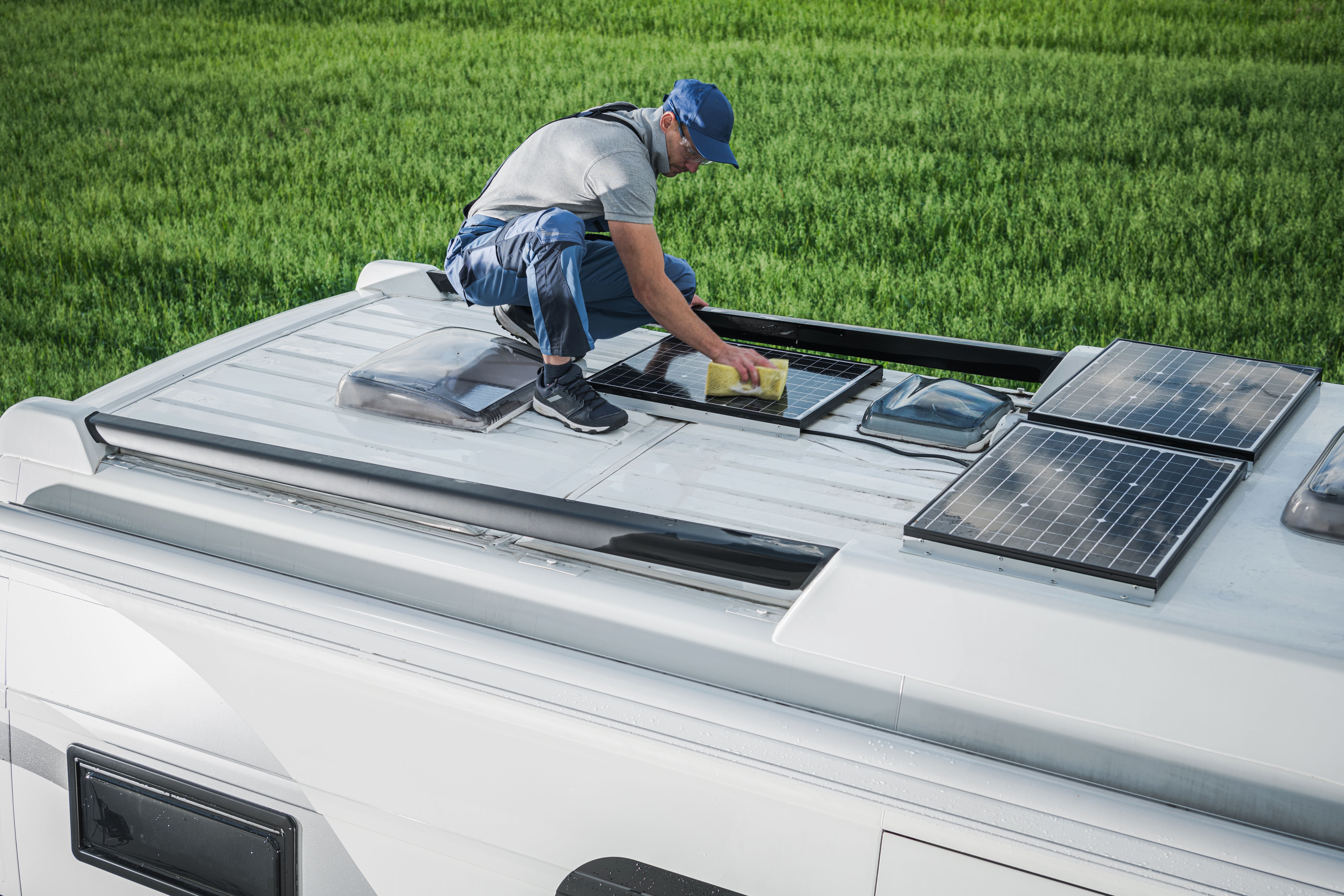 man doing RV solar setup on the roof of his motorhome